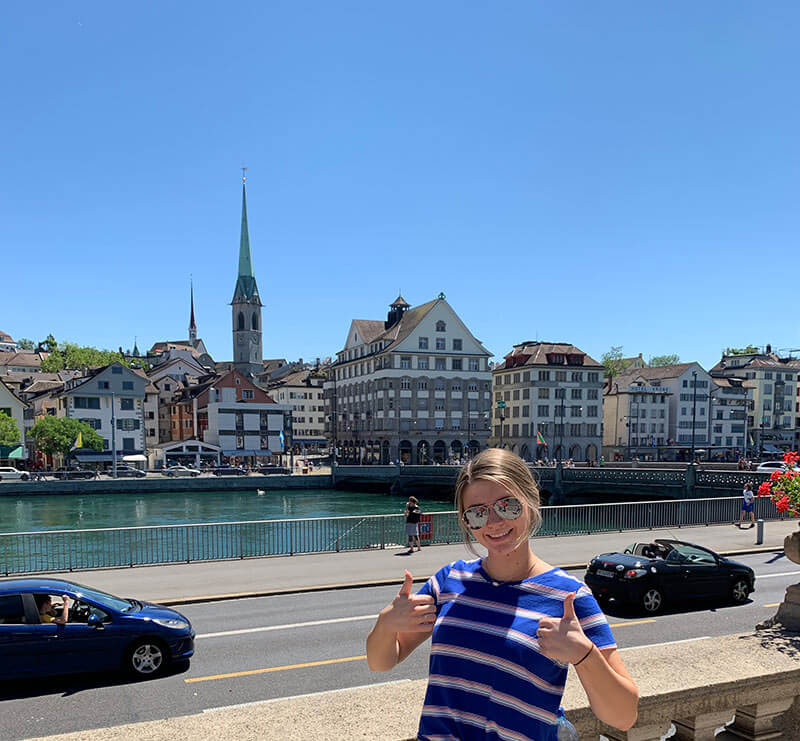 Girl in Zurich, Switzerland poses in front of church
