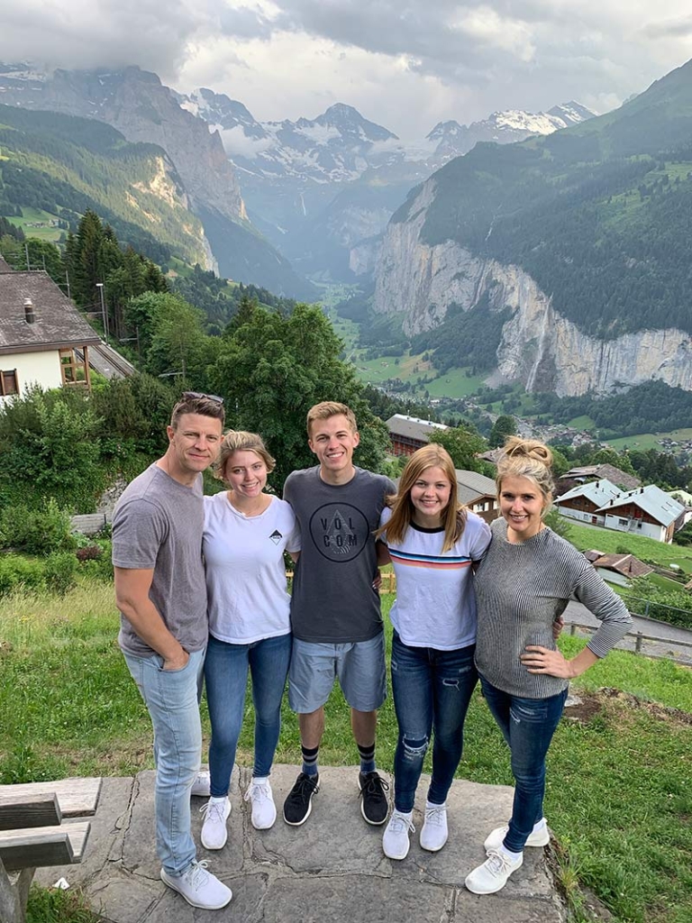Family posing in front of a beautiful view in Wengen, Switzerland