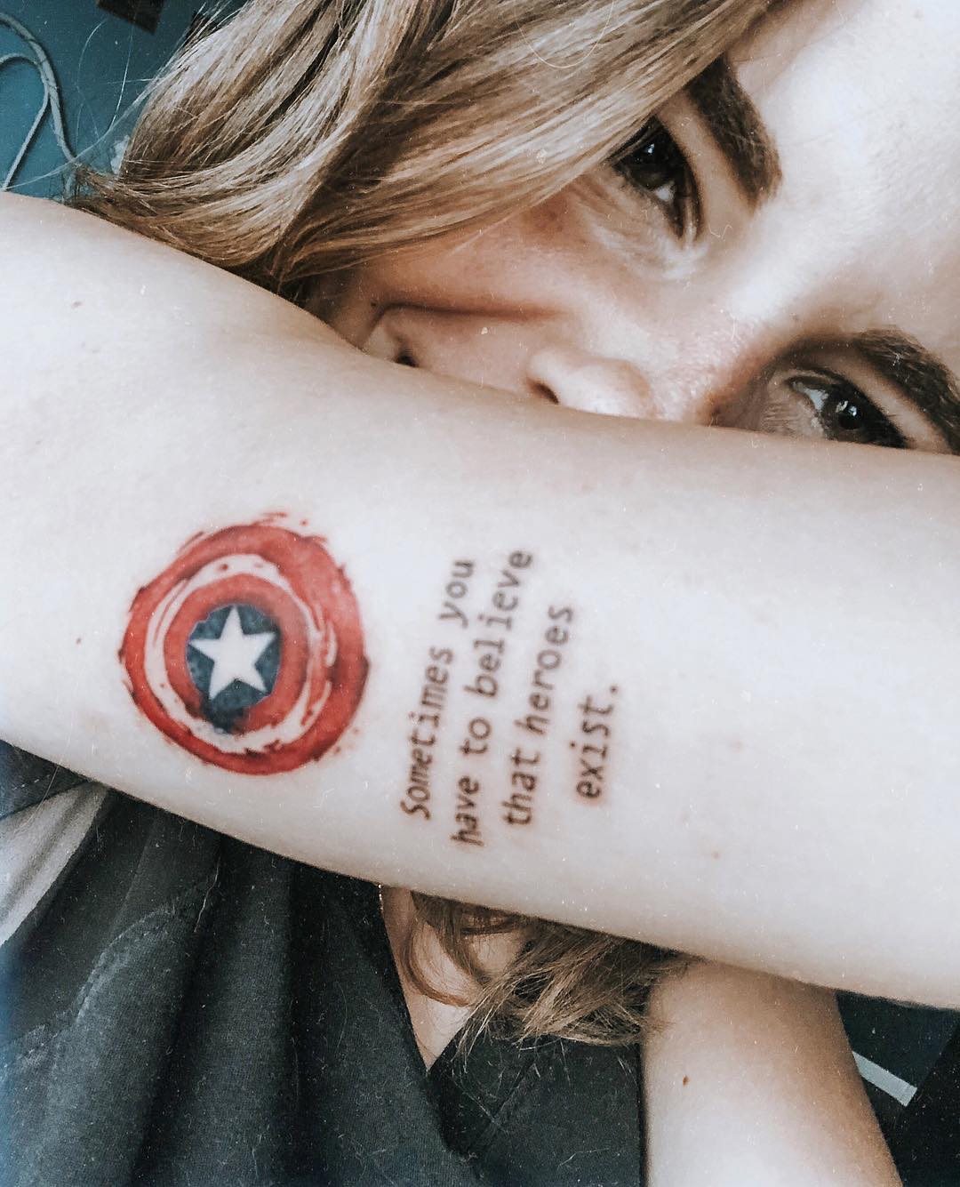 Captain America shield and text tattoo