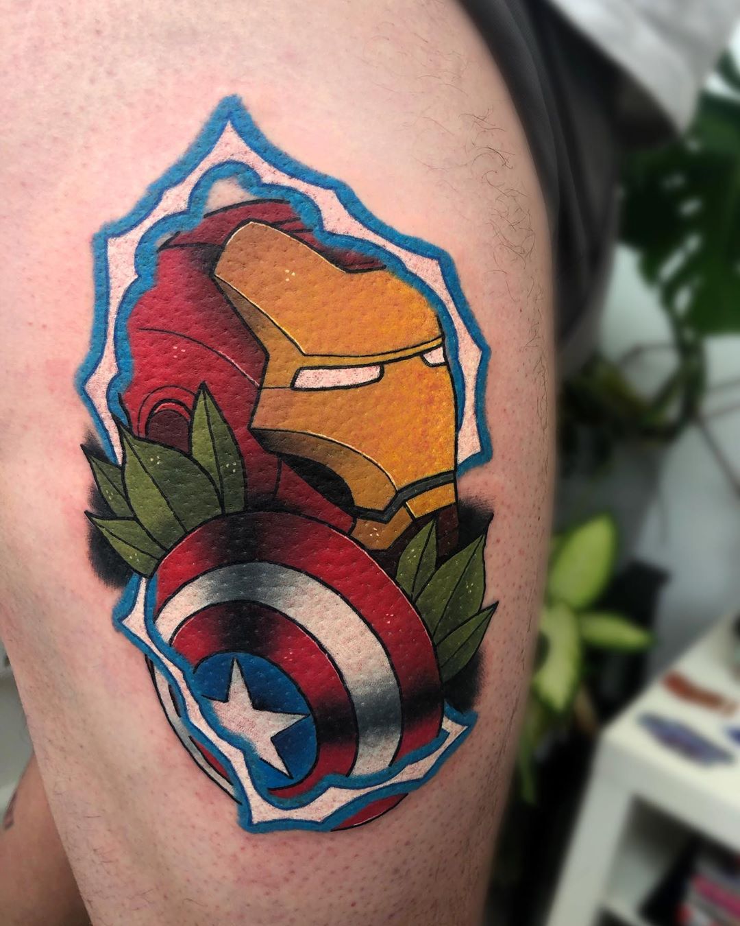 Iron Man holding Captain America's shield tattoo