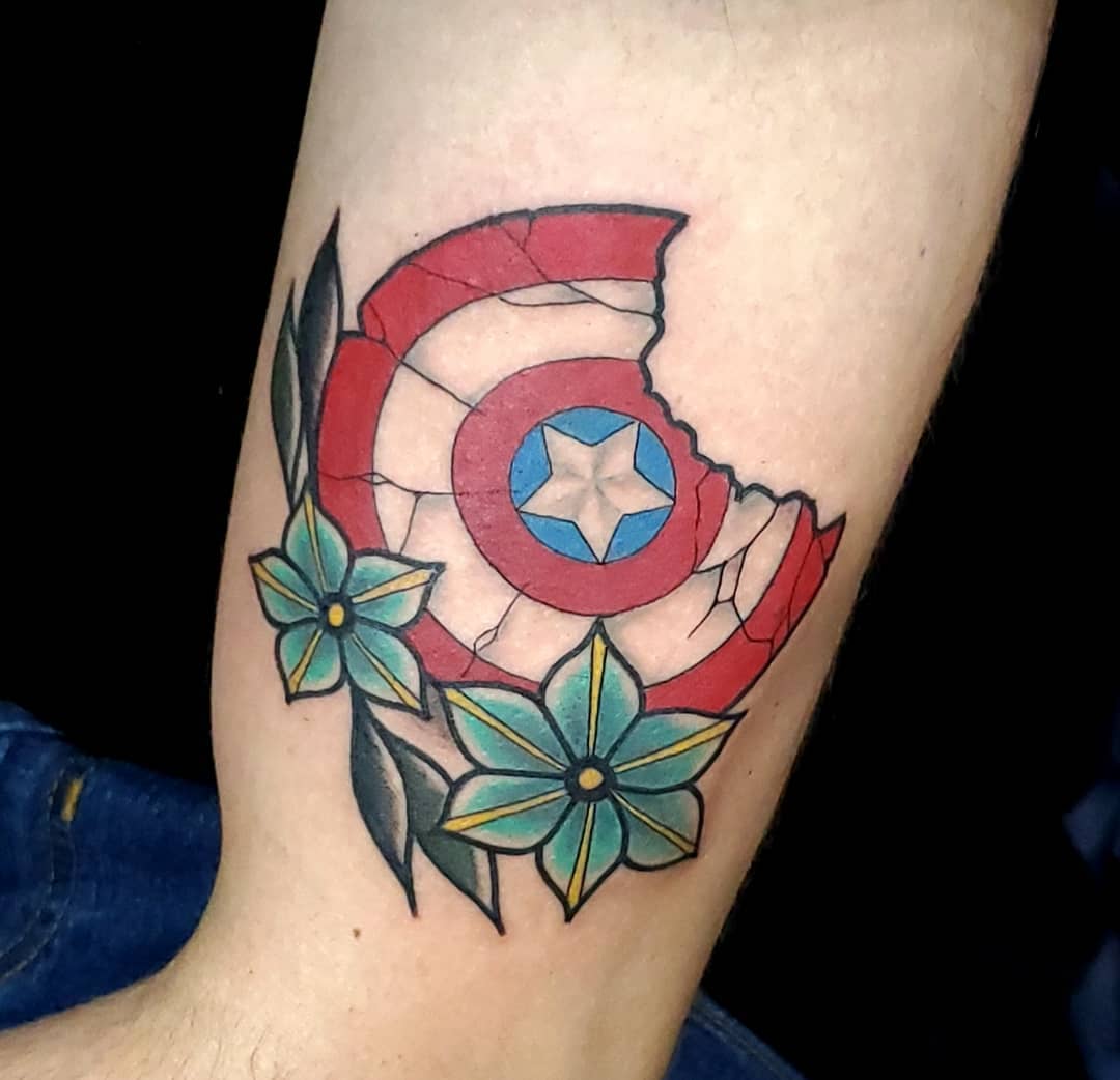 Captain America broken shield and flowers tattoo