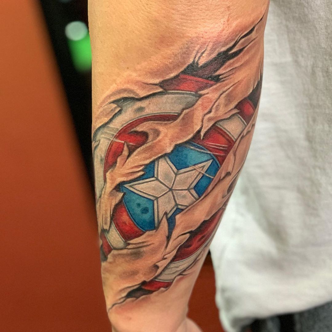 Captain America's shield underneath skin tattoo
