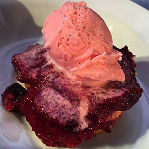berry cake topped with strawberry ice cream