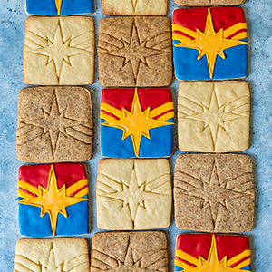 frosted and unfrosted captain marvel themed sugar cookies