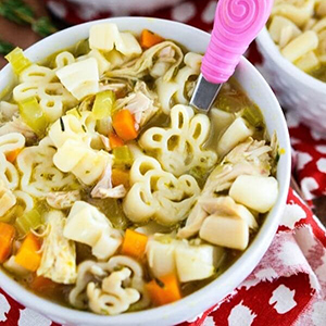 Bowl of Mickey Mouse themed chicken noodle soup
