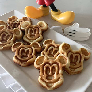 a plate full of mickey mouse themed waffles