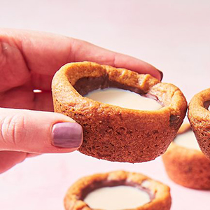 a cookie cup with milk in it