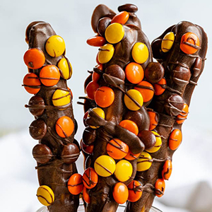 Chocolate-dipped pretzels with Reese's Pieces on them
