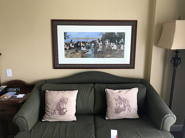 hotel room with couch and picture frame